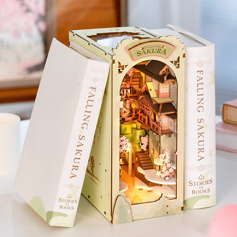 Enter a serene world of cherry blossoms with this DIY book nook, where graceful Eastern architecture blends beautifully with the delicate fall of sakura petals.
Pieces: 240
Assembly Time: ~3 hours
Difficulty Level: ⭐⭐⭐⭐
Assembled Size: H: 9.8″ (25cm) × W: 4.3″ (11cm) × D: 7.5″ (19cm)
